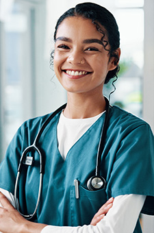 Eine junge Krankenpflegerin lächelt in die Kamera